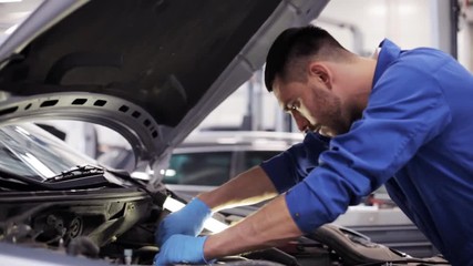 mechanic man with wrench repairing car at workshop 9 - Powered by Adobe