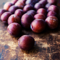 Fresh plums on a dark wooden table..Ripe Plums Texture over vint
