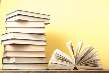 Open book, hardback books on wooden table. Education background. Back to school. Copy space for text.