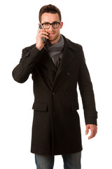 Confident man standing in winter coat talking over phone. Smart