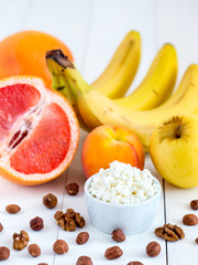 Fototapeta na wymiar dieting cottage cheese with fresh fruits and nuts