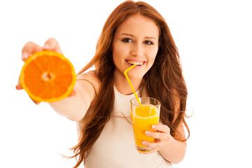 Woman drinking orange juice smiling showing oranges. Young beaut