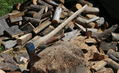 ax of a woodcutter on the block of wood in the woodshed