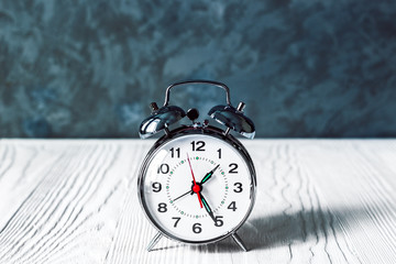 alarm clock at empty locker on white background