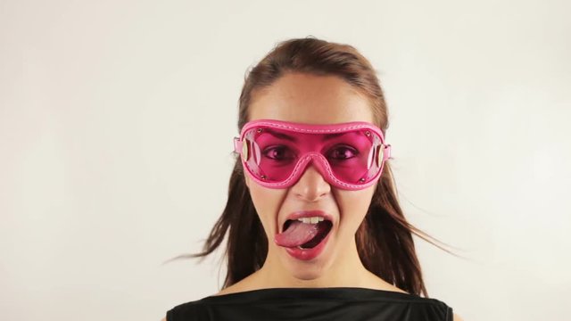 woman wearing retro goggles making faces