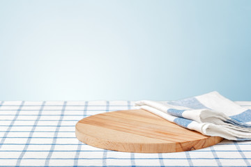 Wooden board with a napkin on a table
