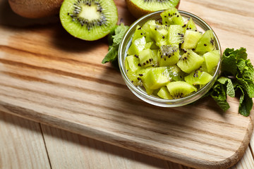 Healthy food. Tropical fruit. Whole and sliced kiwi. Kiwi fruit. Still life. Juicy kiwi on the wooden table