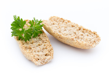 Dry flat bread crisps with herbs on a white background.