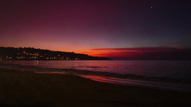 Colorful sunset on the sea . Very beautiful colorful sunset sea ocean palm trees and the lights of the night city