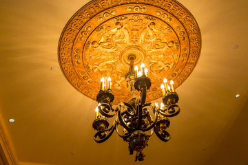 Fototapeta na wymiar Ornate Chandelier on Old Ceiling
