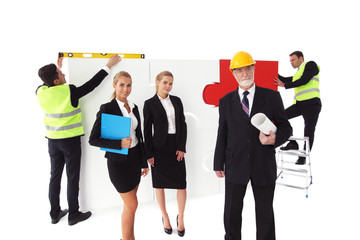 Obraz premium Team of people assembling puzzle