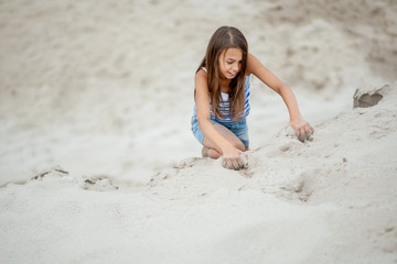 girl climbing on the sand