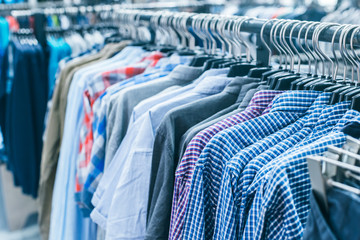 Obraz premium Different clothes on hangers close up
