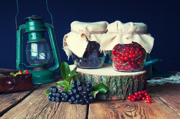 Fototapeta na wymiar Preparations of chokeberry and red currant in jars