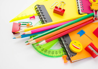 Pens, pencils, erasers, with smileys and a set of notebooks. Schoolchild and student studies accessories. Back to school concept.