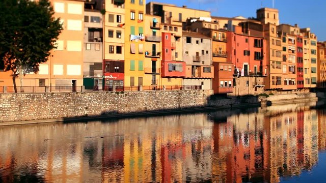 reflection of the old town of girona, spain, in the river