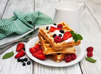waffles with strawberries,  blueberry and milk