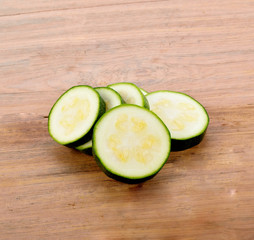 Cucumber slices on wooden table