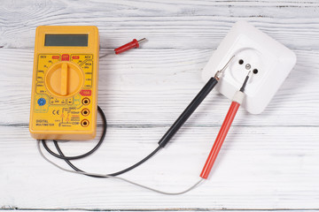 Set of electrical tool on wooden background. Accessories for engineering work, energy concept.