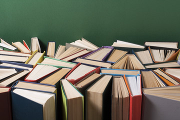 Obraz premium Open book, hardback books on wooden table. Education background. Back to school. Copy space for text.