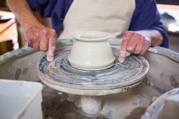 Fototapeta na wymiar Mid section of potter making pot