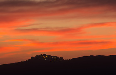 Village of Sant' Antonino in Corsica silhoutted against pink eve