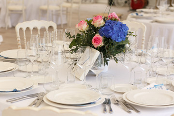 Bouquet of blue hydrangea and pink roses stands in the middle of