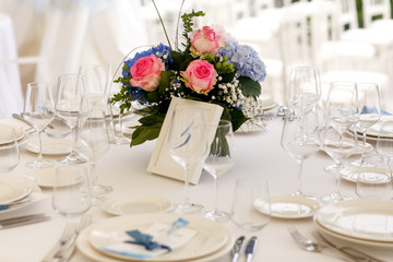 Table number five stands at the delicate wedding bouquet
