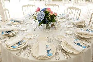 Dinner table served with gorgeous bouquet and festive crockery