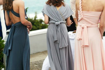 Elegant women in grey, blue and pink dresses standing straight d - obrazy, fototapety, plakaty