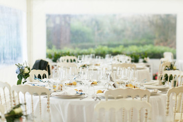 Blurred picture of white wedding pavilion served for a dinner