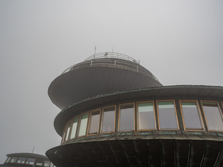 meteo observatory on a top of a mountain in clouds