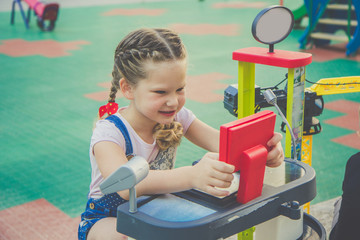 Fototapeta na wymiar Cute girl having fun on a playground