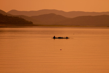 Obraz na płótnie Canvas fisherman with net at the lake