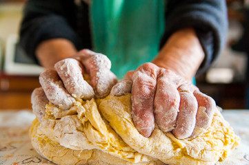 old italian  lady's hands preparing home made italian pasta