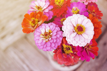 Bright summer flowers on an old wooden surface. Summer background with flowers. Soft focus