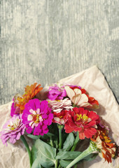 Bright summer flowers on an old wooden surface. Summer background with flowers. Soft focus