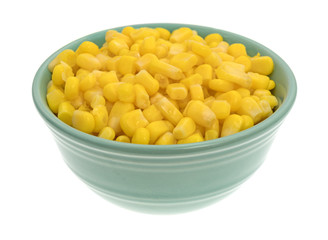 Organic sweet corn in a bowl on a white background.