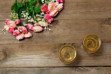 Two glasses of white wine and flowers