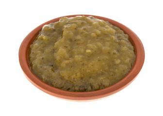 Bowl of culantro cooking sauce on a white background.