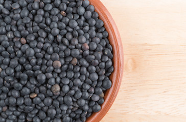 Black beluga lentils in a bowl on a table.