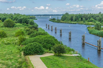 beautiful river landscape with footpath poles and boats sky view