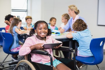 Disabled schoolgirl using digital tablet