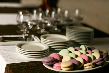 Obraz na płótnie Canvas Sunshine illuminates plate with desserts lying on the table