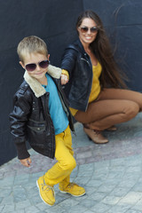 Stylish woman with son on street 