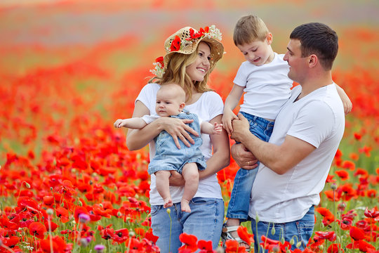 Happy Family In A Red Flowers Field 