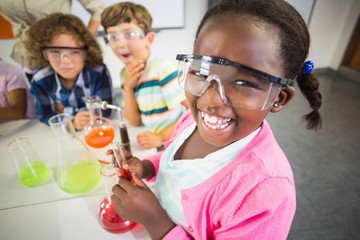 Kids doing a chemical experiment in laboratory - Powered by Adobe