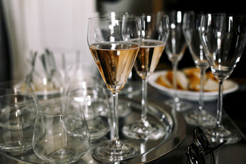 Elegant chamapgne flutes stand on the steel tray
