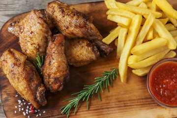 fried chicken wings french fries and sauce