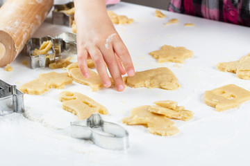 Children's hands knead the dough for baking cookies